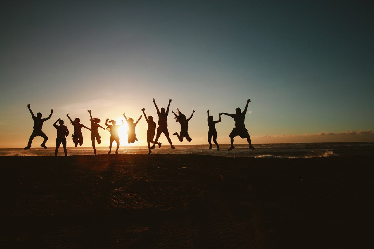 a group of people holding their hands up in the air