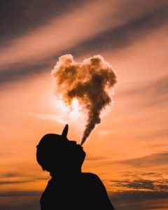 a person looking at a cloud of smoke