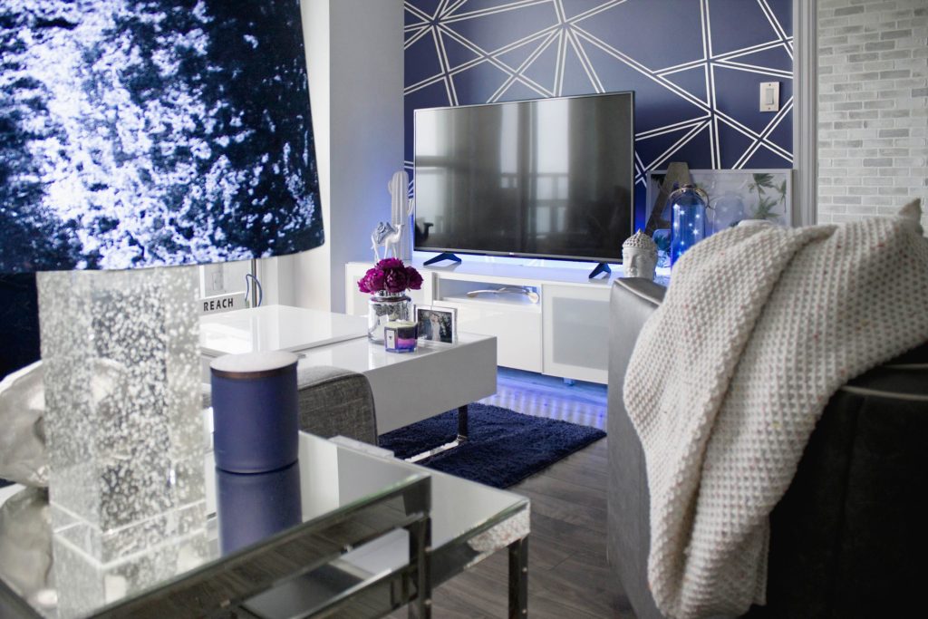 a room with a bed and a television
